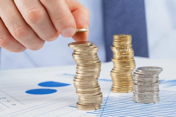 Businessman puts coin — Stock Photo, Image