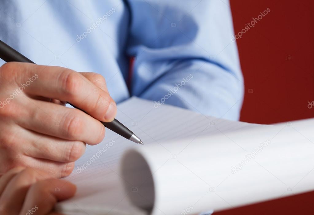 Businessman writing on red