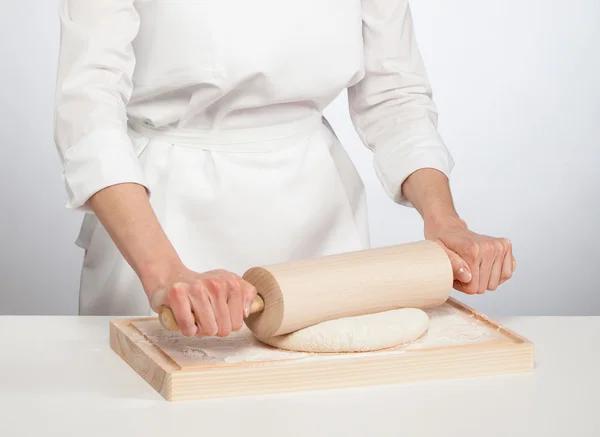 Female chef rolling out dough — Stock Photo, Image