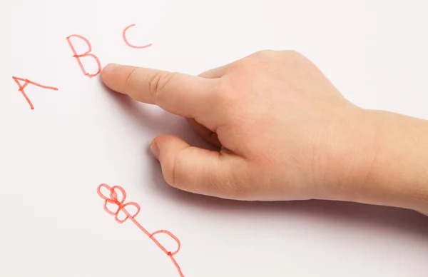 Dedo índice del niño con letras — Foto de Stock