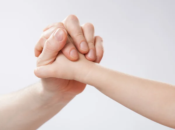 Hands of a child and a father holding together — Stock Photo, Image