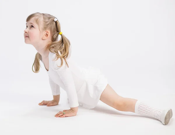 Smiling little girl doing the splits — Stock Photo, Image
