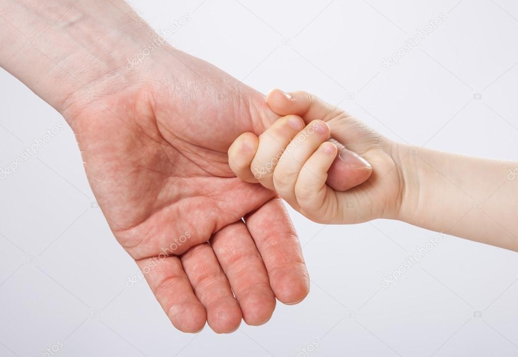 Child holding father's thumb finger
