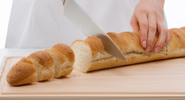 Hands cook cutting bread — Stock Photo, Image