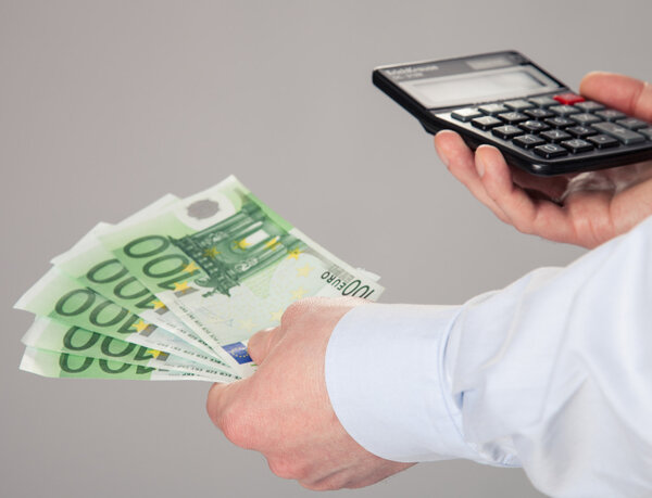 Businessman's hands holding euro banknotes