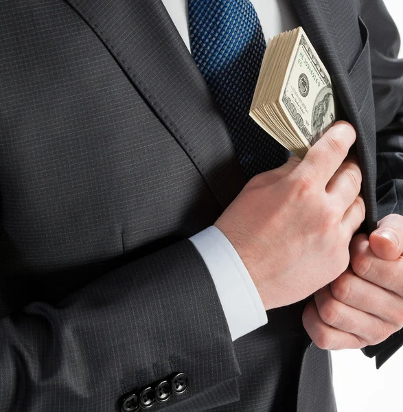 Üzletember pénzt tesz a zsebébe. — Stock Fotó