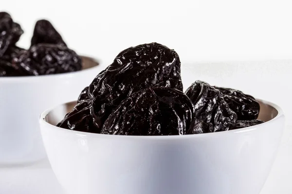 Tasty Prunes in bowls — Stock Photo, Image