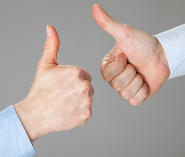 Businessmen gesturing thumbs up