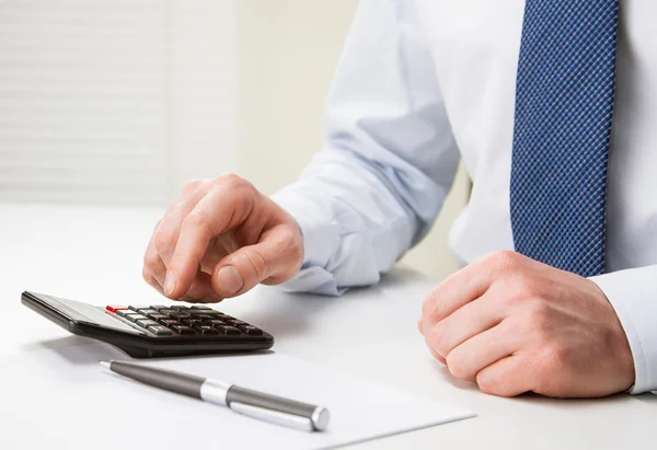 Hands of businessman using calculator — Stock Photo, Image