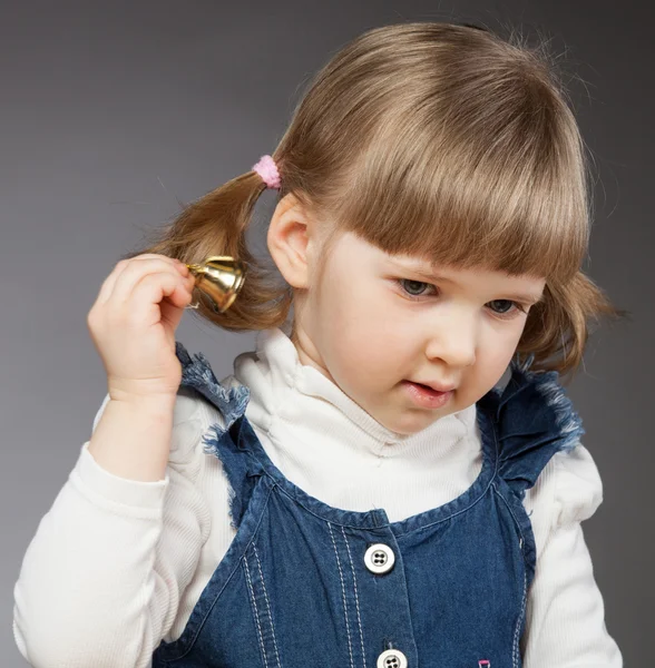 Little girl with golden holiday bell — Stock Photo, Image