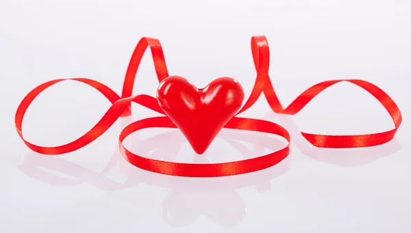 Red ribbon and ceramic heart — Stock Photo, Image