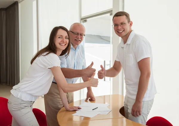 Business people showing thumbs up — Stock Photo, Image