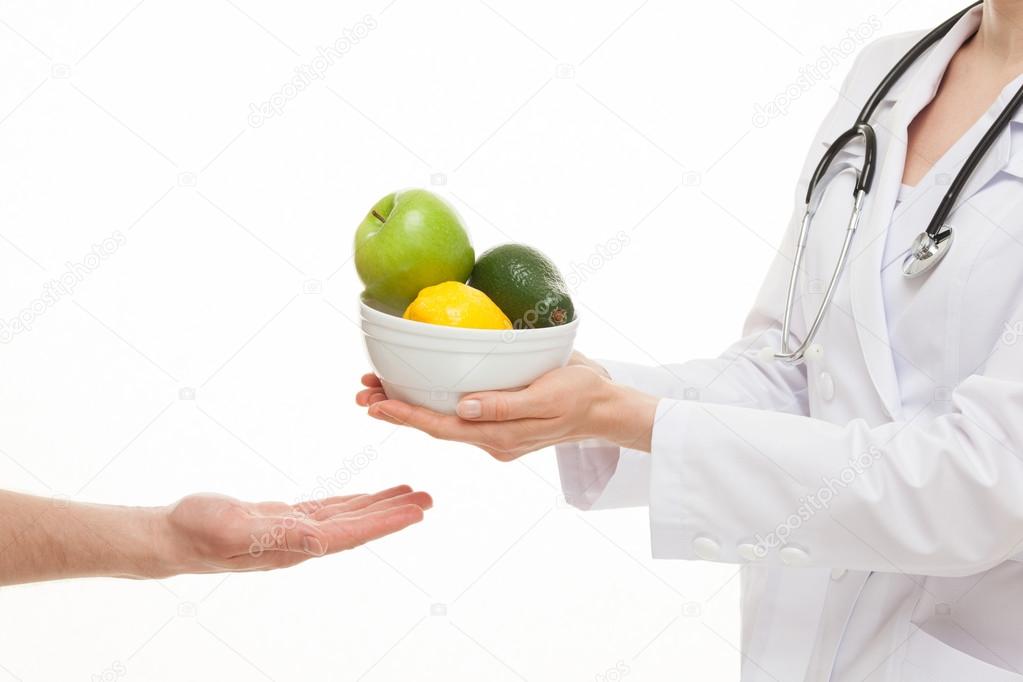Doctor with apple, lemon and avocado