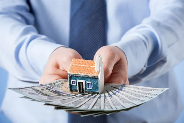 Businessman offering new house — Stock Photo, Image