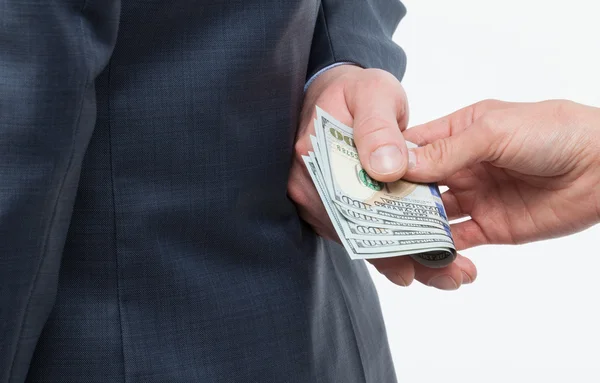 Vrouwelijke hand geven een smeergeld aan zakenman — Stockfoto