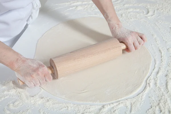 Female cook rolling out dough — Stock Photo, Image