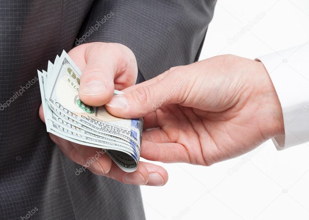 hand giving a bribe to businessman