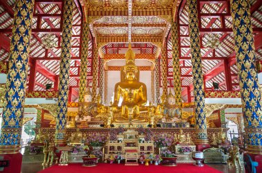 Large golden Buddha statues on the altar at Wat Suan Dok, Chiang Mai, Thailand