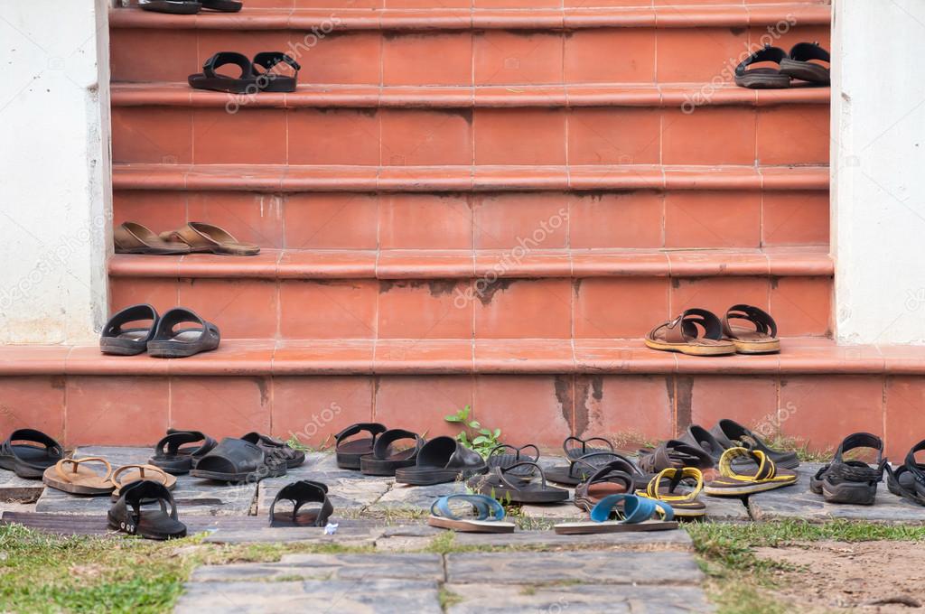 Shoes left on temple steps, Thailand