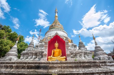 White chedi and golden Buddha statue at Wat Buppharam, Chiang Mai