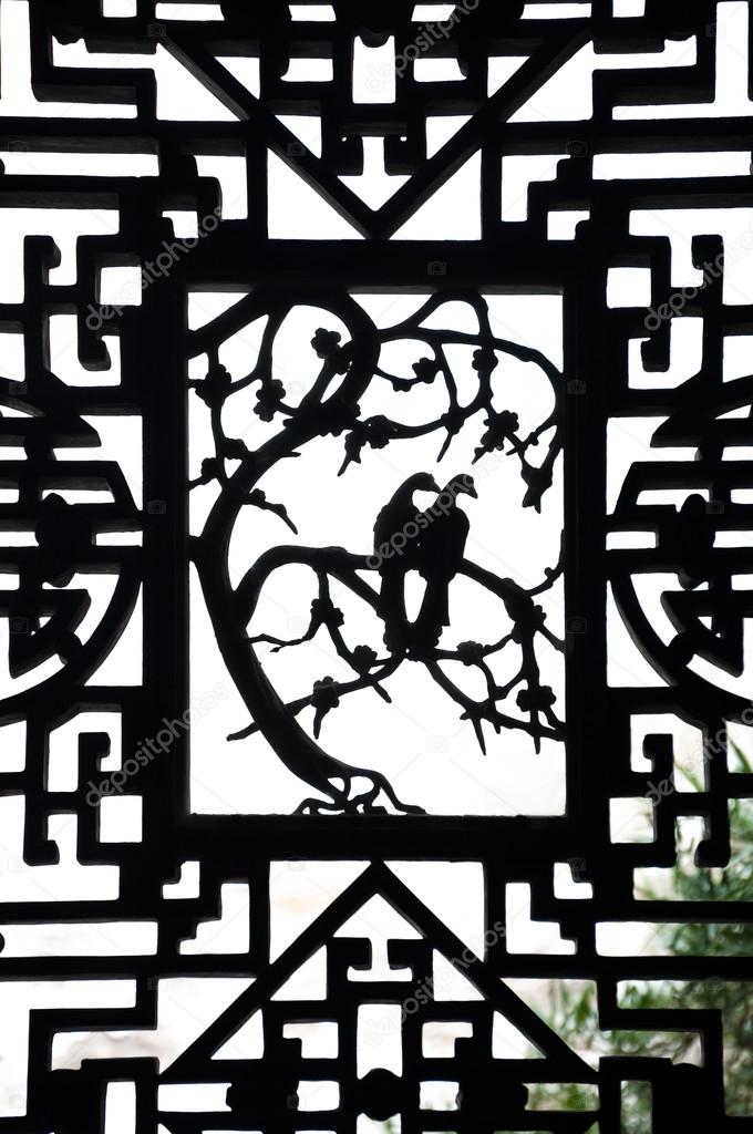 Dove carving on an ornate wooden window at Yuyan Garden, Shanghai