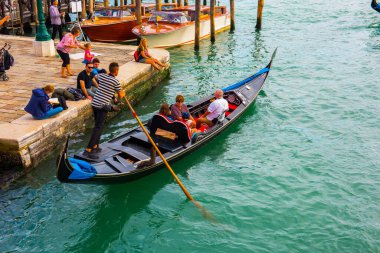 Venedik, İtalya - 23 Eylül 2019 Gondolcu Venedik, İtalya 'da gondolla turistleri taşıyor. Venedik manzaralı geleneksel gondol turu.