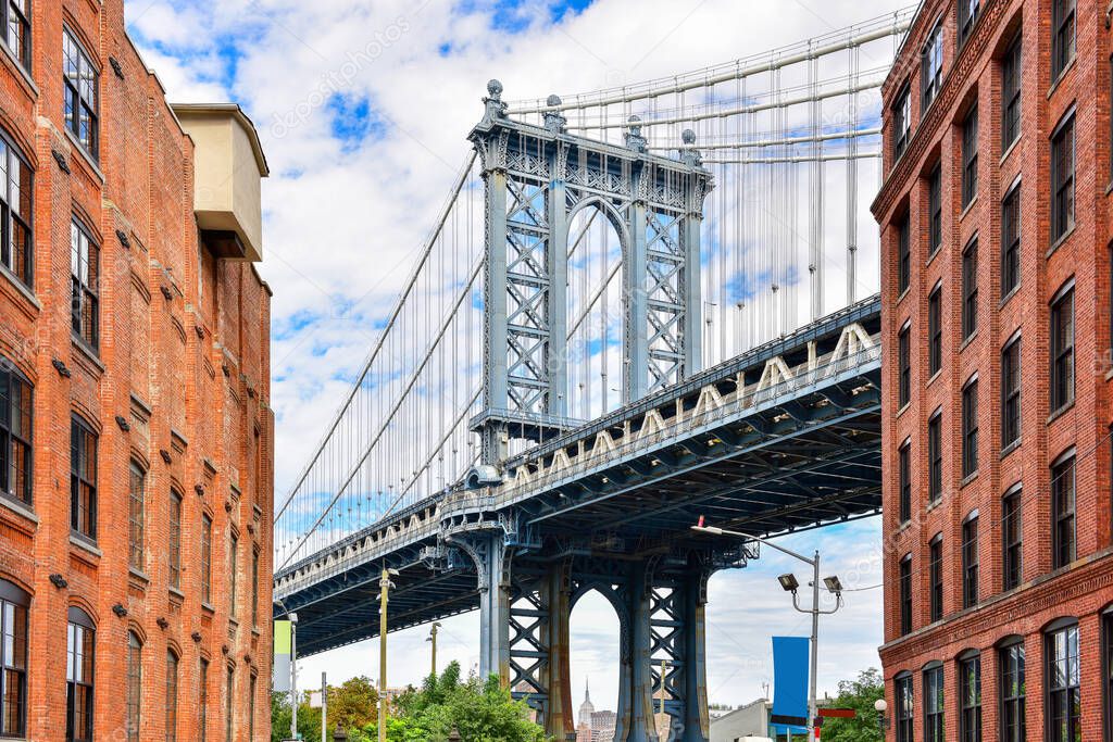 DUMBO district in Brooklyn. NEW YORK, USA. Dumbo is a neighborhood in the New York City borough of Brooklyn. Red buildings and Manhattan Bridge.
