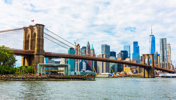 Brooklyn Bridge with skyscrapers background. New York City, USA. Brooklyn Bridge is linking Lower Manhattan to Brooklyn.