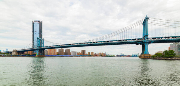 Manhattan Bridge panoramic view. New York City, USA. Manhattan Bridge viewed from Brooklyn Bridge Park.
