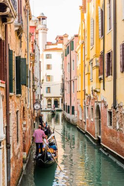 Venedik, İtalya - 23 Eylül 2019 Gondolcu Venedik, İtalya 'da gondolla turistleri taşıyor. Geleneksel Venedik gondolu ünlü kanalda. Güzel Venedik manzarası.