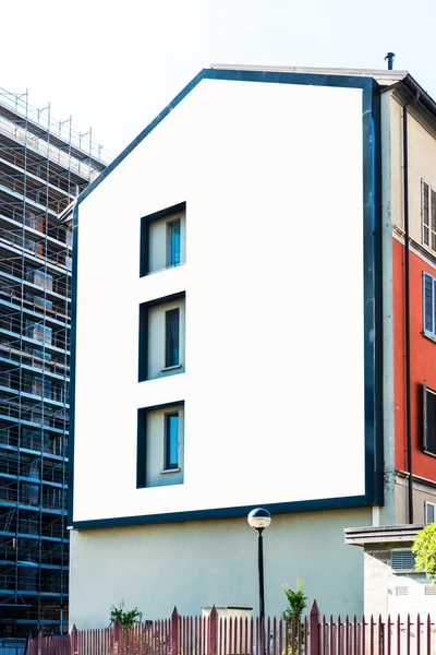 Large blank billboard on building for outdoor advertising in Milano, Italy.