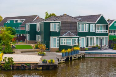 Zaanse Schans 'da geleneksel Hollanda evleri ve yel değirmenleri. Zaanse Schans, Hollanda 'nın Amsterdam kentinde yer alan küçük bir köydür..