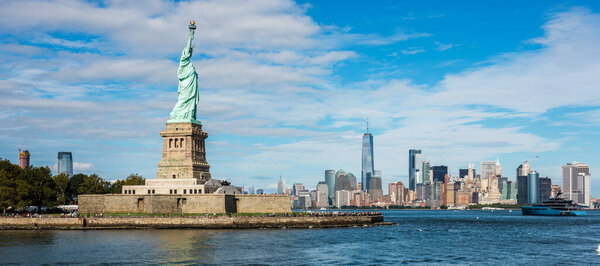 Statue of Liberty National Monument with Manhattan skyline background. New York, USA.