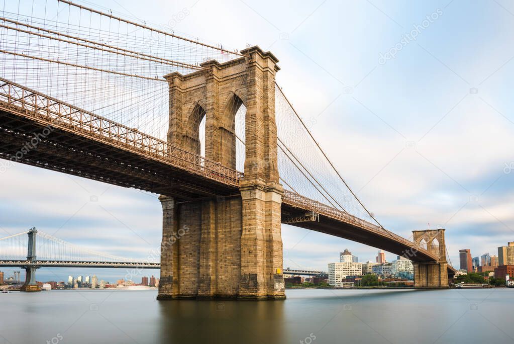 Brooklyn Bridge at sunset view. New York City, USA. Brooklyn Bridge is linking Lower Manhattan to Brooklyn.