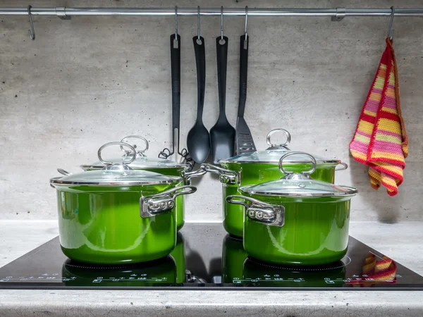 Four stewpots on induction cooker — Stock Photo, Image