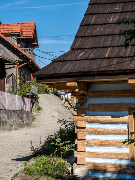 LANCKORONA, POLAND - OCTOBER 4 2015: Rural road with wooden cottages in historical village Lanckorona located in the Southern part of Poland