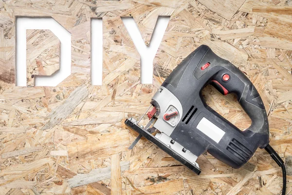 DIY acronym cut out in OSB panel — Stock Photo, Image