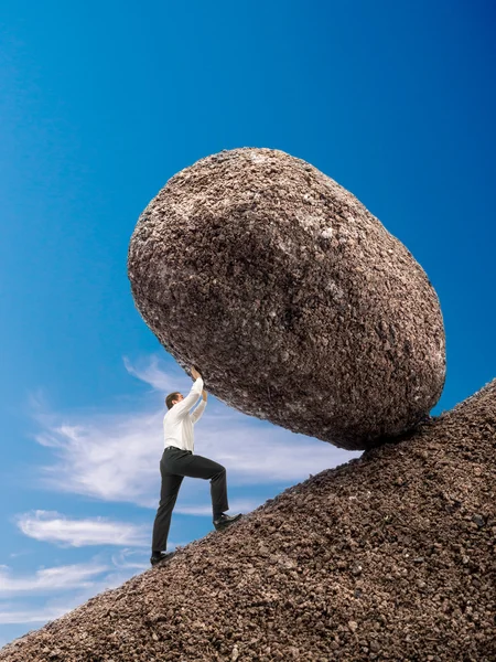 Businessman pushing up boulder — Stock Photo, Image