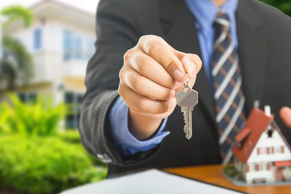 Businessman show Keys for your good property — Stock Photo, Image