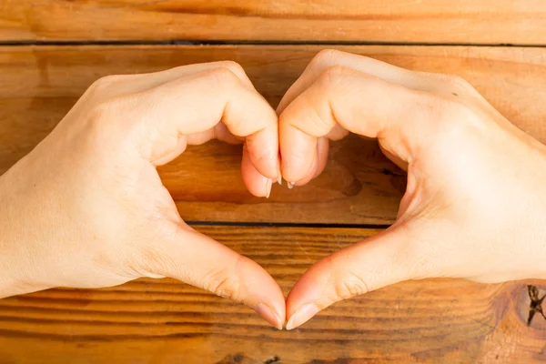 Female make hands heart on valentine day — Stock Photo, Image