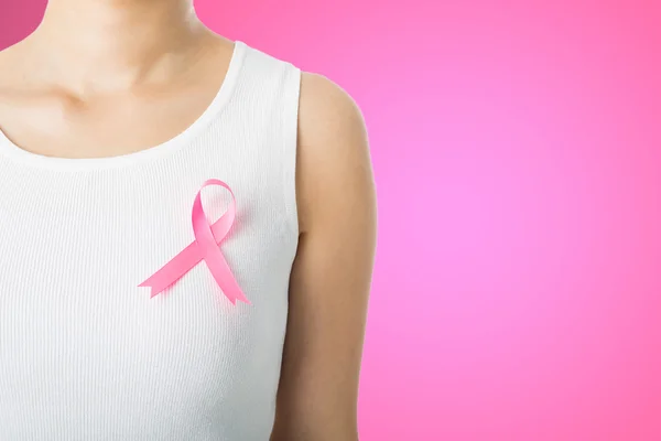Pink Breast cancer awareness ribbon sticked by woman who need to show healthcare concept.