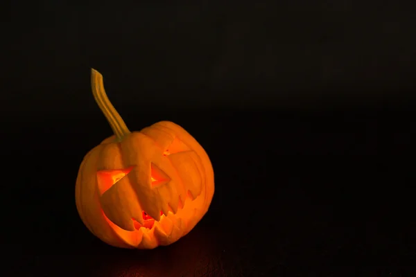 Halloween pumpkin lantern scary face in October.