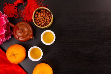 Flat lay Chinese new year mandarin orange and tea water with top view Copy space  for celebrate china festival.hinese characters ZHAO CAI JIN BAO in the article refer to lucky fortune ,wealth, rich
