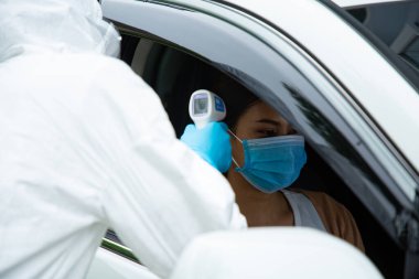 PPE tıp çalışanı. Sıcaklığı kontrol et. Corona virüsü hastalığını bul. Sıcaklık silahı ile enfeksiyonu tara.