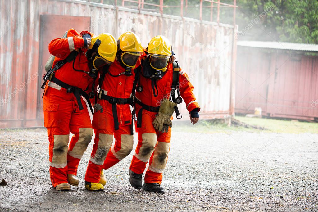 Fire fighter team support friend after accident inside dangerous area.Protection and support together.cooperative assoication unity teamwork concept.