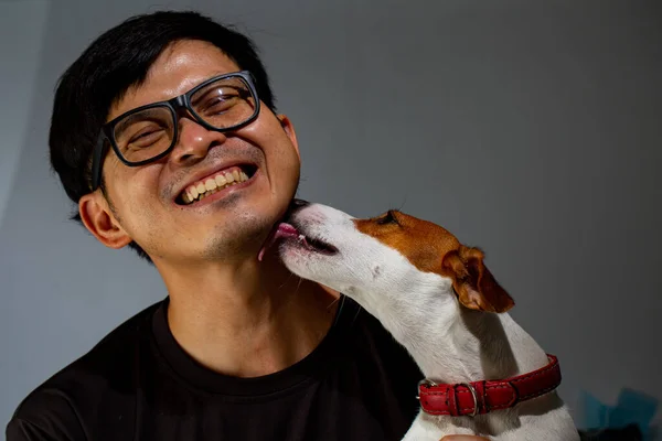 Asian man and dog take photo for keep memorial together in studio.