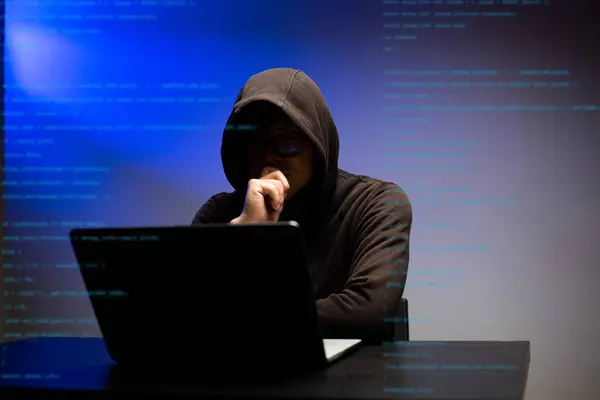 Hacker hooded dangerous hacking information government data servers and get password for insert their virus to system.