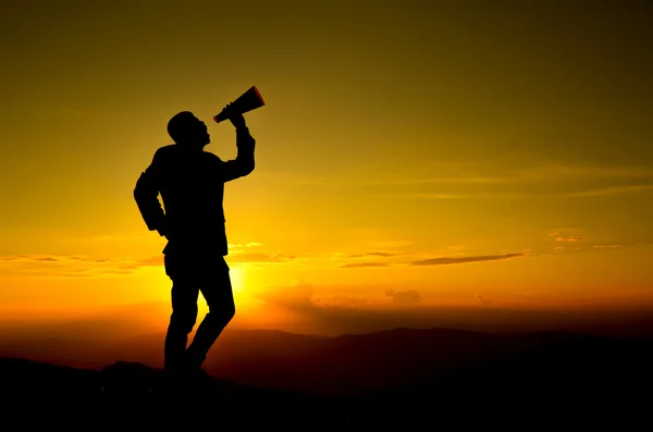 Businessman shouting for announce through a red loudspeaker — Stock Photo, Image