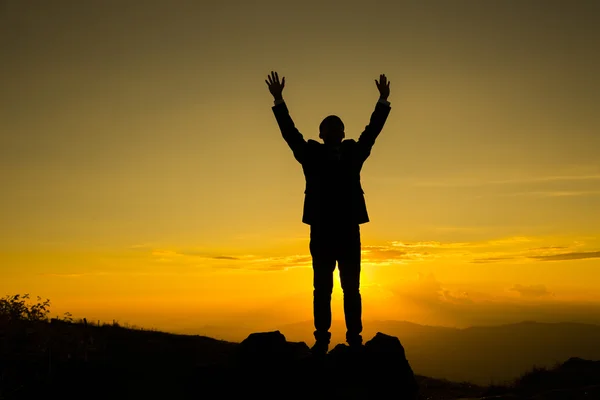 Busineesman show two hand after go to peak of mountain — Stock Photo, Image