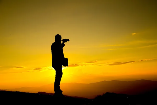 Businessman hold laptop and watch binoculars for his vision — Stock Photo, Image